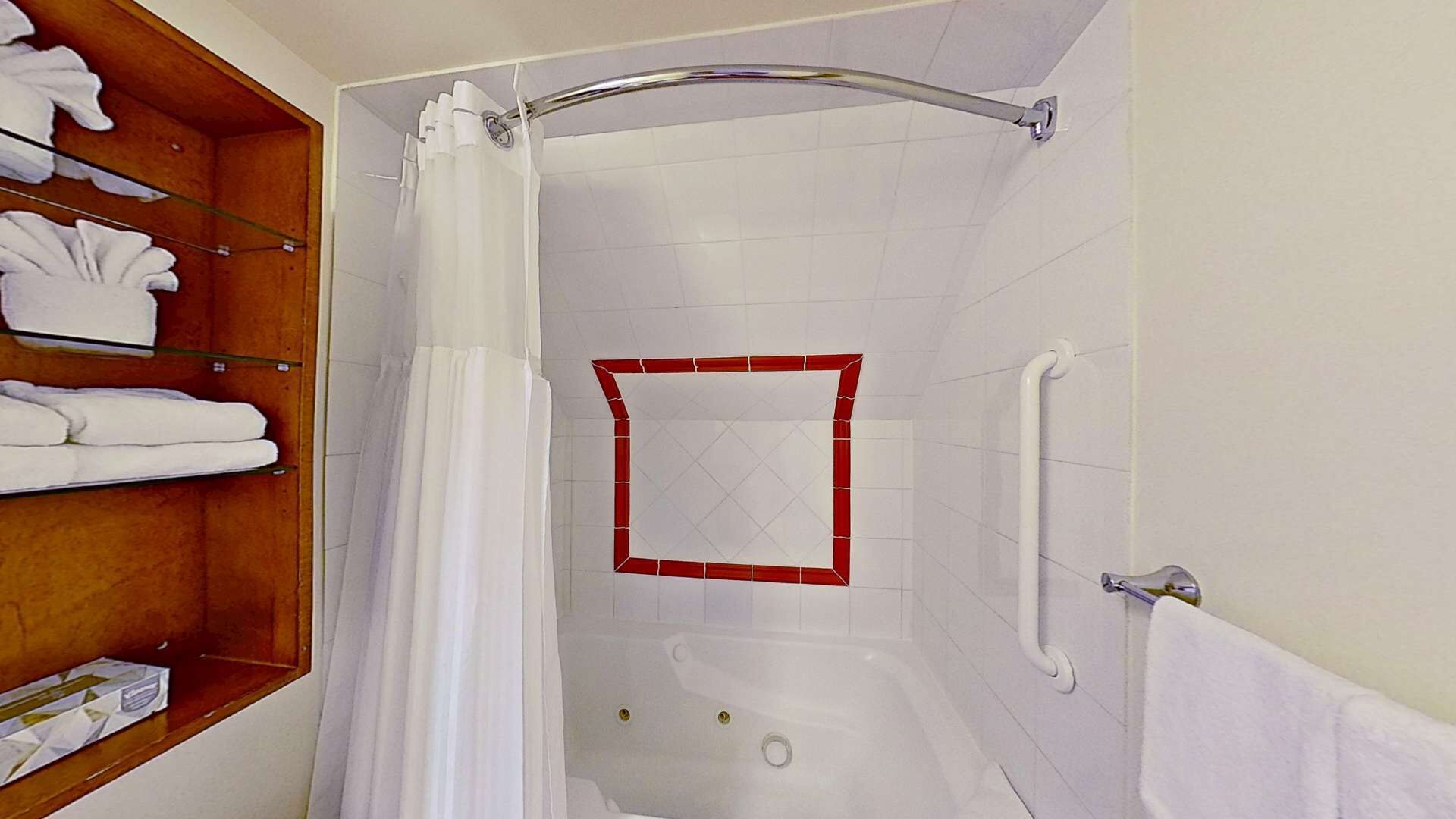 A bathroom with a shower, a bathtub, and a shelf with towels.