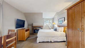 A bedroom with a bed, a TV, a desk, a wardrobe, and a window. - Whistler - Whistler Peak Lodge 501 (Whistler)