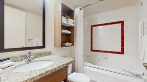 A bathroom with a sink, mirror, towel rack, shower, and toilet. - Whistler - Whistler Peak Lodge 611 (Whistler)