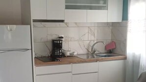 A kitchen with white cabinets, a coffee maker, and a sink. - Acheron Flow by ΜΡS (Acherontas)