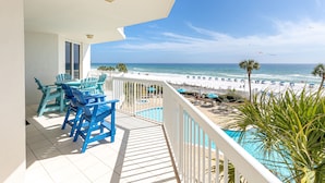 A balcony with a view of the beach, a pool, and outdoor furniture. - Silver Beach 0306e 3 Bedroom Condo (Destin)