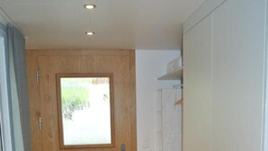 A room with a wooden door, a window, and a white wardrobe. - Blaues Haus by Interhome (Appenzell)
