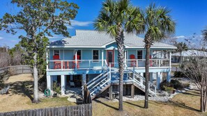 A two-story house with a covered porch and a staircase leading to the upper level. - Mexico Beach w/Low Speed Vehicle (Mexico Beach)