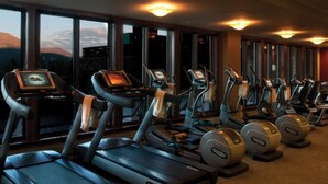 A gym with treadmills and elliptical machines, large windows with a mountain view, and exercise equipment. - Lux Slope-side 1BR.2BAw/FullKitchen, 1 King, 1 Queen Sofa  @ Grand Lodge Peak 7 (Breckenridge)