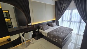 A modern bedroom with a bed, a desk, and a chair.