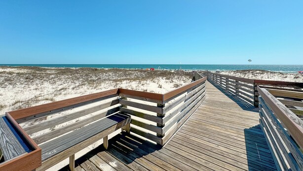 A wooden boardwalk leading to a beach with a clear sky. - New! Beachfront 2BR, Stunning Gulf Views, Indoor/Outdoor Pools, Hot Tubs (Gulf Shores)