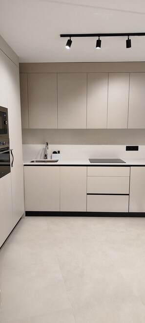 A modern kitchen with a built-in oven, a sink, and a countertop. - Center Brand New duplex Private pool (Nerja)