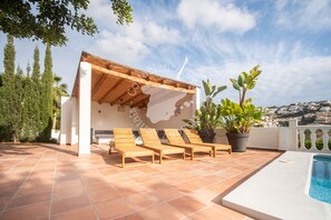 A rooftop terrace with a pool, wooden lounge chairs, and potted plants. - CostaBlancaDreams - Casa Amahle in Moraira (Moraira)
