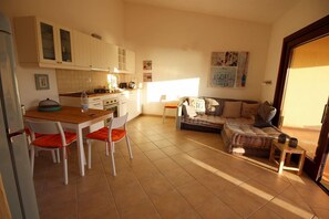 A compact living space with a kitchen, dining area, and seating area. - Villetta Salley, A/C, stunning sea view (Costa Paradiso)