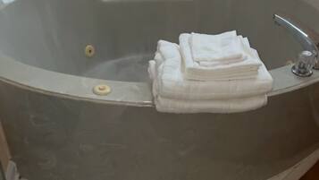Jetted tub, towels, toilet paper
