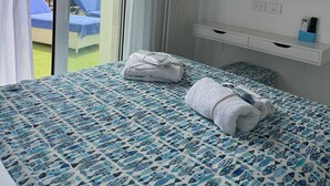 A hotel room with a bed, a TV, and a balcony with a view of the countryside. - Apartment Sky Garden Rapallo Maria Jose Liguria-Attico sea view-Idro-Box (rapallo)