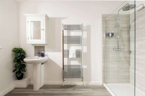 Shower, hair dryer, towels, shampoo