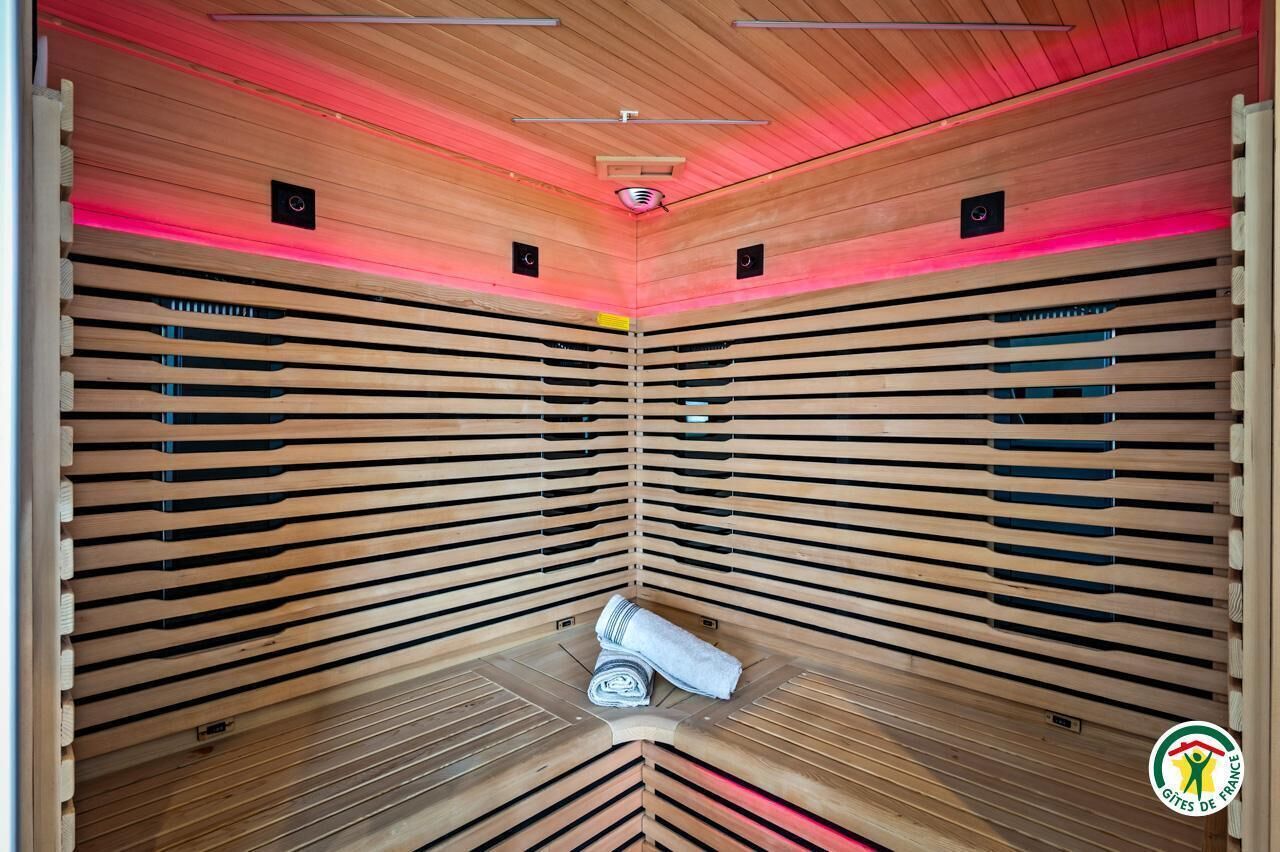 A sauna with wooden slats and a towel on the floor.