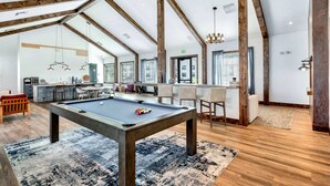 A spacious room with a pool table, wooden beams, and a bar area. - Charming 3-bedroom Villa with garage in Madison-sleeps 10 (Madison)