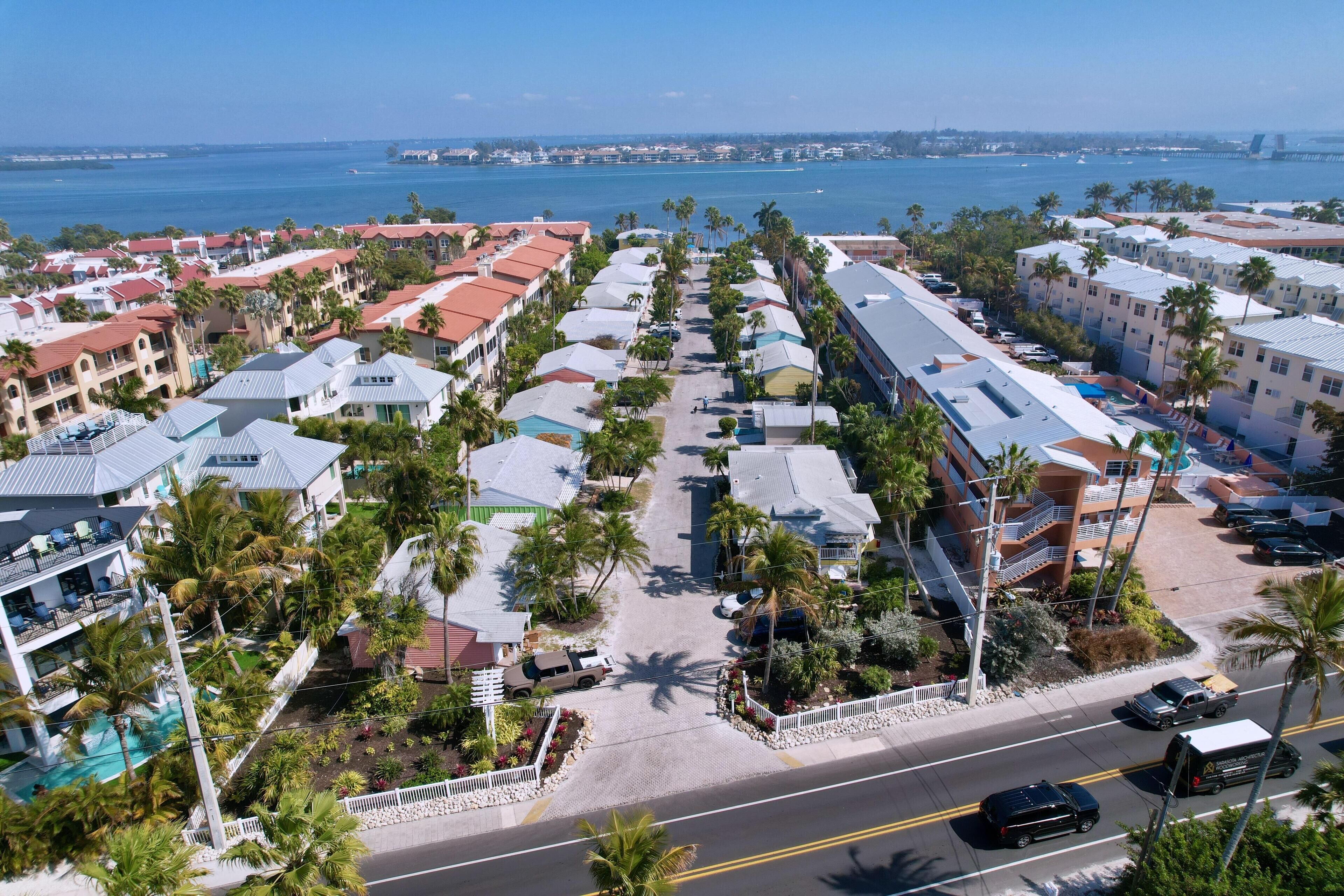 A coastal hotel with multiple buildings, a swimming pool, and a view of the ocean.