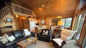 A cozy cabin interior with a living room, kitchen, and dining area. - 
Picturesque 4 - Bedroom Lakefront Cabin on the popular Minong Flowage (Minong)