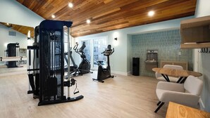 A home gym with exercise equipment, a dining area, and a kitchen. - Dillon Lakefront Luxury w Iconic Mountain Views. Walk to Marina & Amphitheater (Dillon)