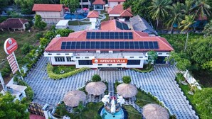 A villa with a red roof, solar panels, a swimming pool, and thatched umbrellas. - Infenta's Villa (Pandatharippu)