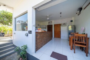 A modern kitchen with a brick backsplash, a wooden counter, and a refrigerator. - Samula Uluwatu (Pecatu)