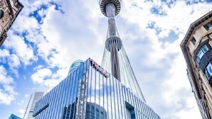 A modern hotel with a prominent tower structure, large glass windows, and a visible sign for 'Westfield'. - Luxury Spacious 3BR Family Home Walk To Harbour Bridge/ Opera House& CBD (Millers Point)