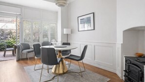 A modern dining area with a round table, chairs, and a pendant light. - Luxury Spacious 3BR Family Home Walk To Harbour Bridge/ Opera House& CBD (Millers Point)