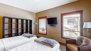 A hotel room with two beds, a TV, a chair, and large windows. - Okanagan - Spyglass 4C (Beaverdell)