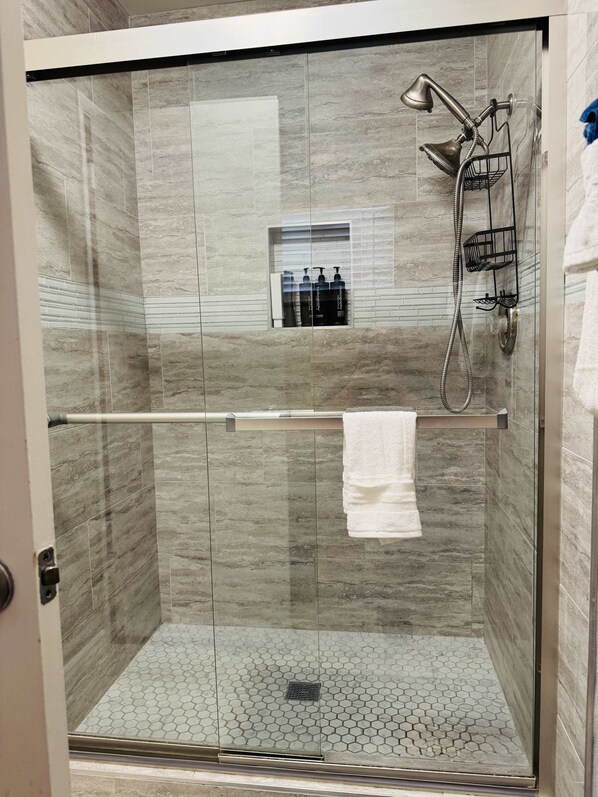 Shower, hair dryer, towels, shampoo