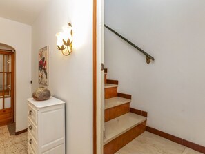 A staircase with wooden steps and a metal handrail, leading to an upper floor. - Town Plaza Palafrugell by Interhome (Palafrugell)