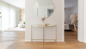 A modern bathroom with a round mirror, a gold-framed vanity, and a patterned wall. - NEW Bright 36 with garden [Treviso - Venice]. (Treviso)