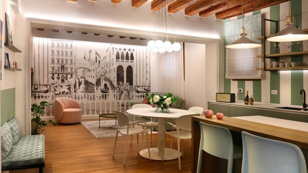A modern kitchen with a round dining table, white chairs, and a bar area with stools. - Address: Calle del Forno, 3776 - CastelloGoogle maps' position : https://maps.app.goo.gl/8ZB3pERQmRtSMLuj6The apartment is located on the ground floor, completely restored and finely furnished, consisting of two bedrooms (one double and one with two sing (Venezia)