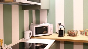 A kitchen with a microwave, kettle, and coffee maker on a wooden countertop. - Address: Calle del Forno, 3776 - CastelloGoogle maps' position : https://maps.app.goo.gl/8ZB3pERQmRtSMLuj6The apartment is located on the ground floor, completely restored and finely furnished, consisting of two bedrooms (one double and one with two sing (Venezia)