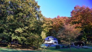 A house surrounded by dense trees and a well-maintained lawn. - La Bellevue forest-edge cottage (Hénouville)