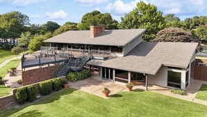 A modern two-story house with a covered patio, a staircase, and a well-maintained lawn. - 6 Mi to Dtwn Garland: Group Getaway w/ Pool Access (Garland)