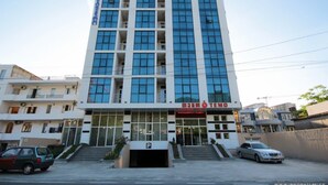 A multi-story building with a prominent entrance and a sign that reads "TEMPO". - Hotel Temo (Batumi)