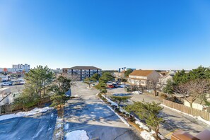 A parking lot with snow on the ground, surrounded by trees and buildings. - Pool, Sunset Views & Prime Setting! Ocean City Gem (Ocean City)