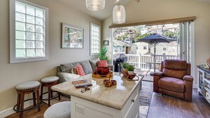 A spacious kitchen with a large island, wooden stools, and a ceiling fan. - Walk to Bay & Pleasure Pier! Catalina Island Stay (Avalon)
