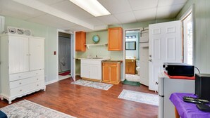 A spacious kitchen with wooden cabinets, a white refrigerator, and a built-in oven.