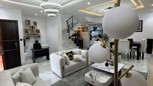 A modern living room with a sofa, coffee table, and a unique spherical lamp.
