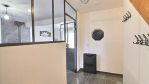 A modern hallway with a glass partition, a black trash bin, and a coat rack. - House sleeps 7, 10 minutes walk from the beach Pets welcome (Plurien)
