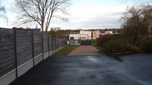 A residential driveway leading to a modern two-story house with a garage. - House sleeps 7, 10 minutes walk from the beach Pets welcome (Plurien)