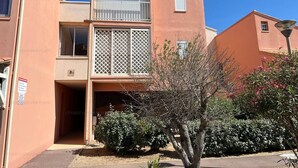 A two-story building with a balcony, a small window, and a door. - Cozy Nest in Narbonne for 4, near beach, includes parking (Narbonne)