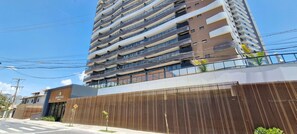 Un edificio de varios pisos con diseño moderno, con balcones y ventanas amplias.
