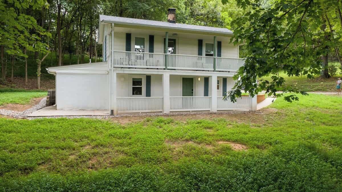 Front view of the house surrounded by trees