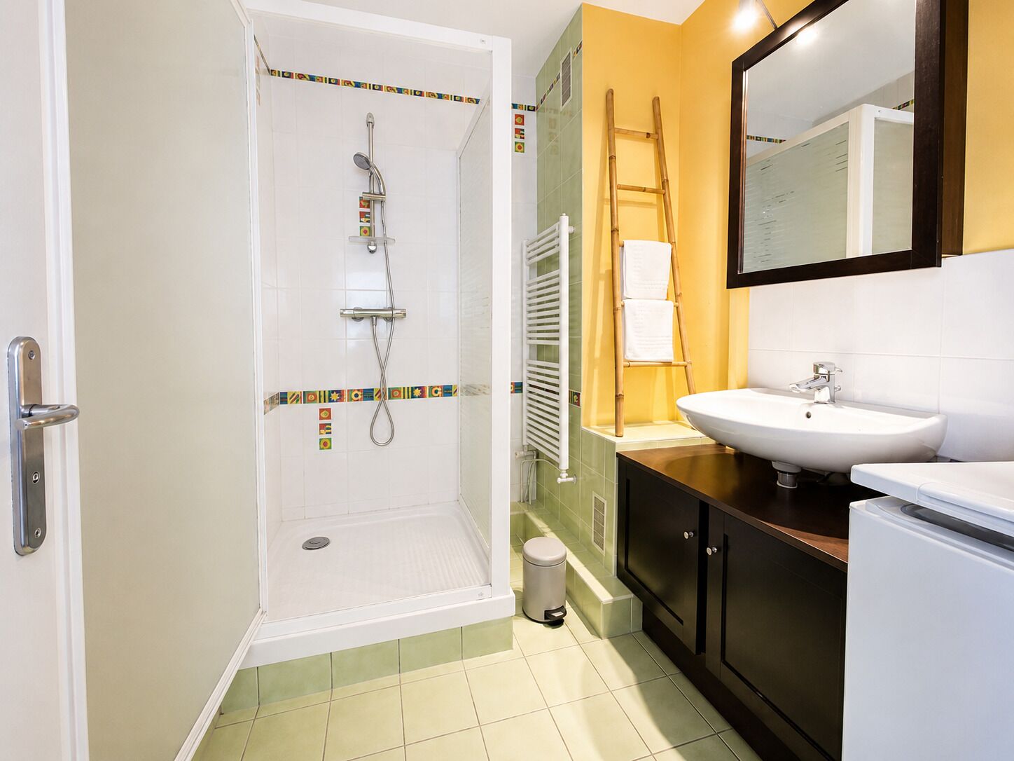 A bathroom with a shower, sink, and toilet.