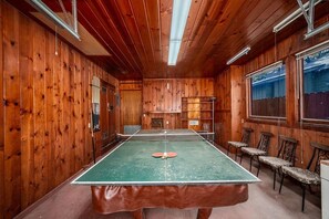 A ping pong table in a room with wooden walls and ceiling, a window, and a door. - Al Tahoe Cabin-Vintage Meets Modern 3 Bed, 2 B (South Lake Tahoe)