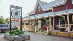 A building with a porch and a sign that reads "Octopus Cafe."