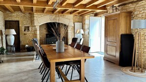 A rustic dining room with a wooden table and chairs, stone walls, and a fireplace. - Where authenticity meets the comforts of today.Includes covered private terrace (Blanquefort-sur-Briolance)