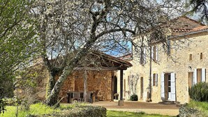 A stone building with a covered patio, a grassy lawn, and a stone wall. - Where authenticity meets the comforts of today.Includes covered private terrace (Blanquefort-sur-Briolance)