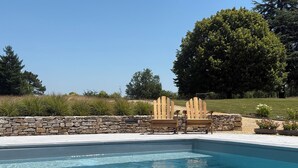 A swimming pool with two Adirondack chairs and a stone wall. - Where authenticity meets the comforts of today.Includes covered private terrace (Blanquefort-sur-Briolance)