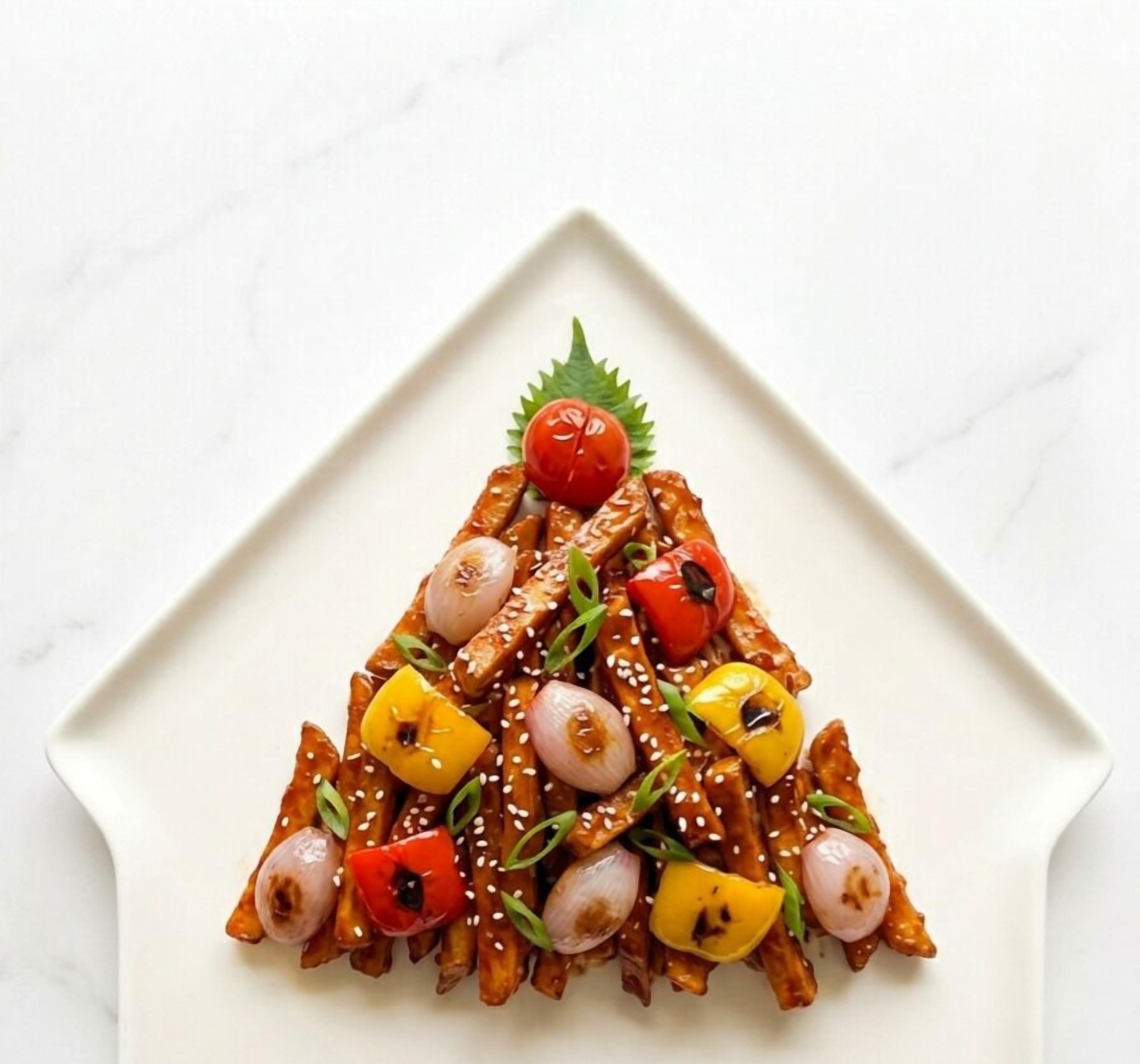 A triangular arrangement of food on a white plate.